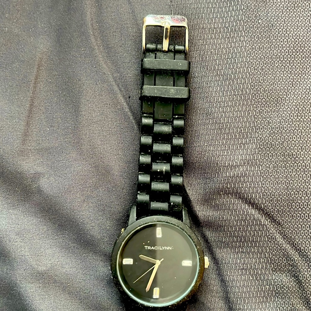 Watch face with four rhinestones and the Traci Lynn name in the middle.